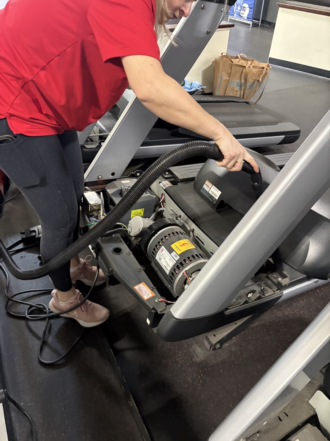 Dustbusters technician detail-cleaning fitness equipment